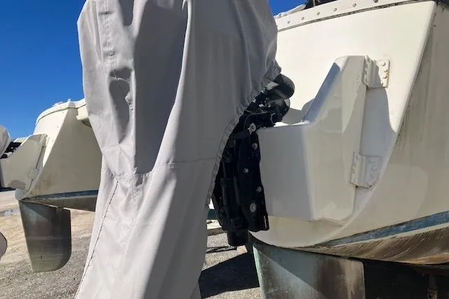 Slide: The Image of Outboard motor on 1981 Witness Catamaran, parked on gravel under clear blue sky. - 6