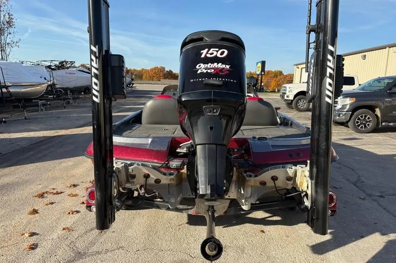 Slide: The Image of 2011 Ranger Z118 Comanche boat with OptiMax Pro XS engine, parked outdoors. - 3