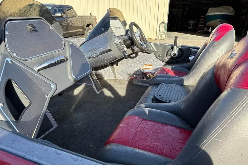 Slide: The Image of 2011 Ranger Z118 Comanche boat interior with red and black seats, steering wheel, and dashboard. - 7