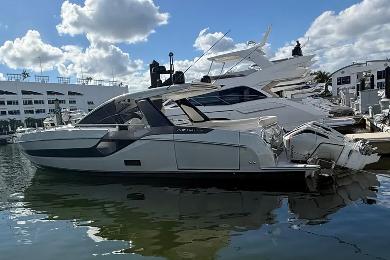 The Image of 2023 Azimut Verve 47 luxury yacht docked at marina, showcasing sleek design and powerful engines. - 0