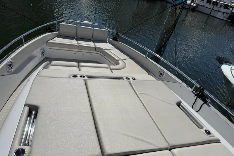 Slide: The Image of 2023 Azimut Verve 47 yacht docked, rear view with four engines, named "Chicken Money." - 10