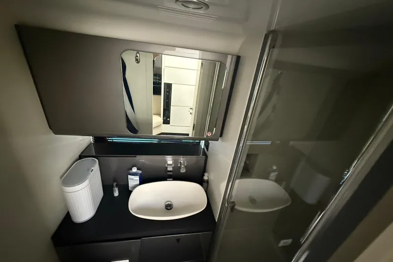 Slide: The Image of Modern bathroom interior of 2023 Azimut Verve 47 yacht, featuring sleek sink and mirror. - 101