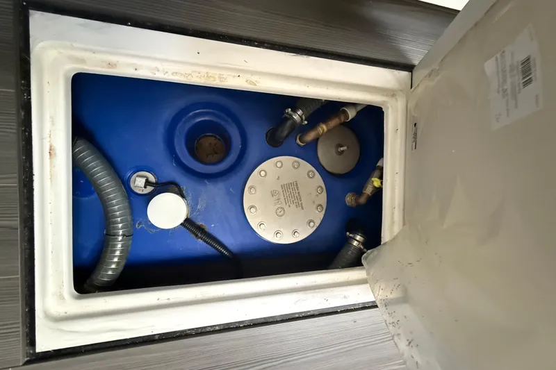 Slide: The Image of 2023 Azimut Verve 47 yacht's engine compartment with blue tank and hoses. - 103