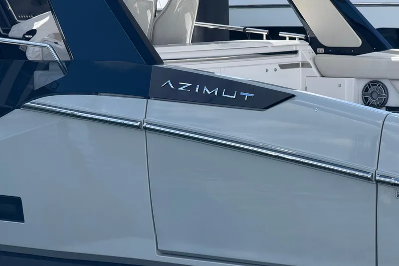 Slide: The Image of 2023 Azimut Verve 47 luxury yacht docked at a marina, showcasing sleek design and powerful engines. - 2