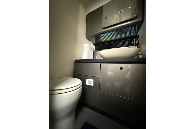 Slide: The Image of 2023 Azimut Verve 47 yacht interior entrance with control panel and marina view. - 38