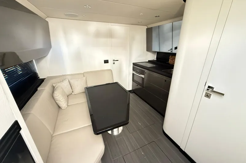 Slide: The Image of Cockpit view of 2023 Azimut Verve 47 yacht with modern controls and docked boats. - 42