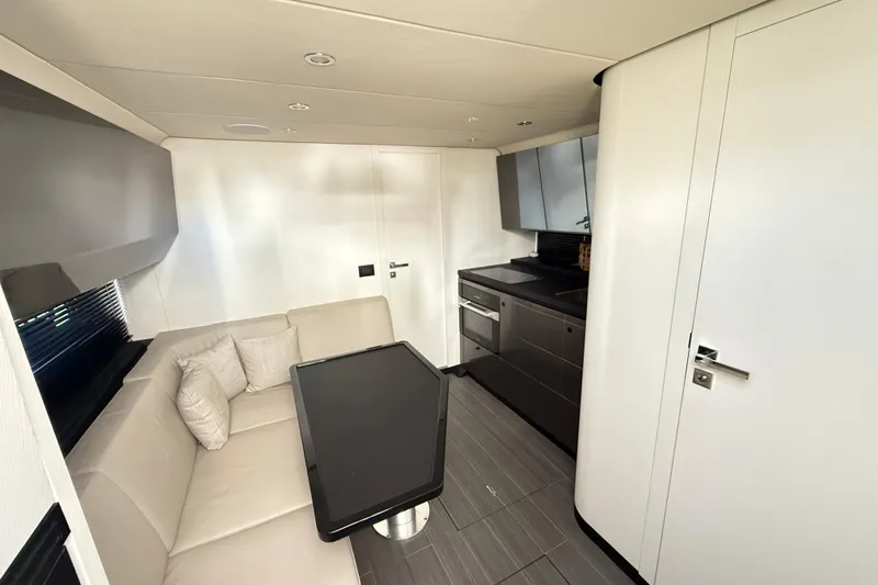 Slide: The Image of 2023 Azimut Verve 47 yacht docked at marina, modern helm, luxury setting. - 44