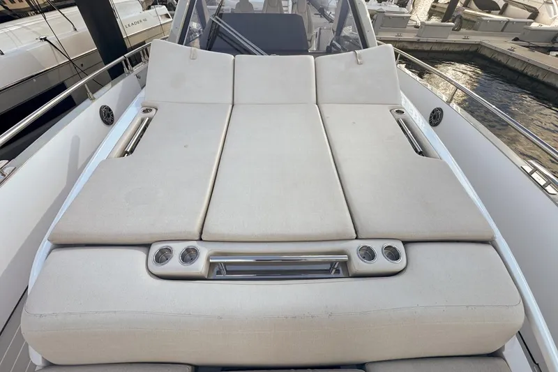 Slide: The Image of Luxurious sunbed on 2023 Azimut Verve 47 yacht, featuring comfortable cushions and cup holders. - 54