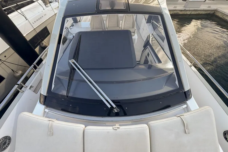 Slide: The Image of 2023 Azimut Verve 47 yacht, top view of cockpit and windshield at marina. - 56