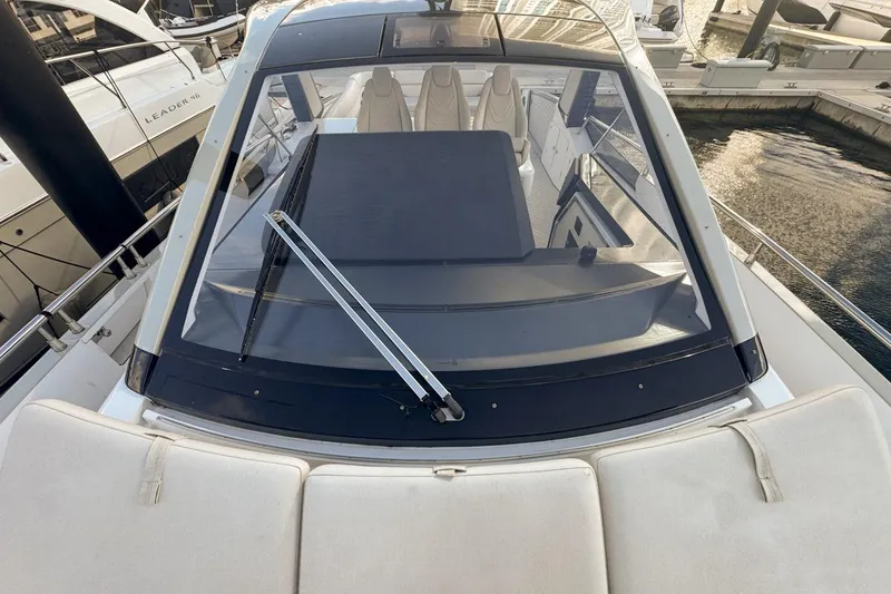 Slide: The Image of 2023 Azimut Verve 47 yacht, top view of cockpit and seating area at marina. - 57