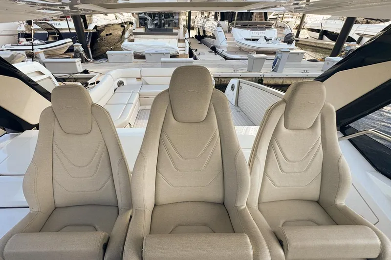 Slide: The Image of Three beige seats on 2023 Azimut Verve 47 yacht, docked at marina. - 59