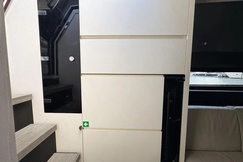 Slide: The Image of Interior of 2023 Azimut Verve 47 yacht, featuring modern stairs and sleek cabinetry. - 66