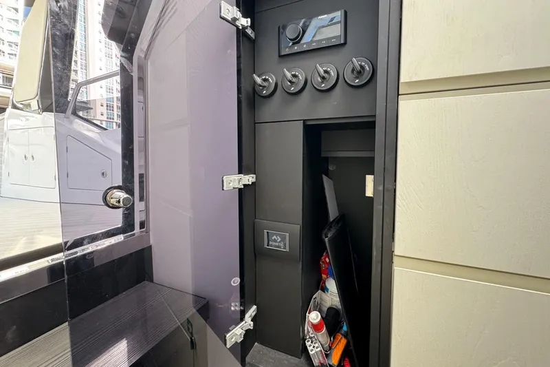Slide: The Image of 2023 Azimut Verve 47 yacht interior storage compartment with control panel and accessories. - 67