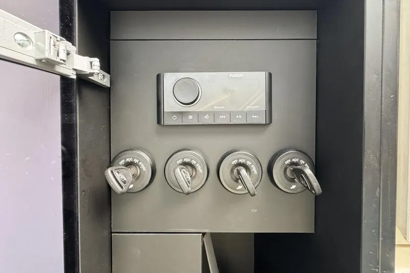 Slide: The Image of Control panel of a 2023 Azimut Verve 47 boat with ignition switches and audio system. - 68