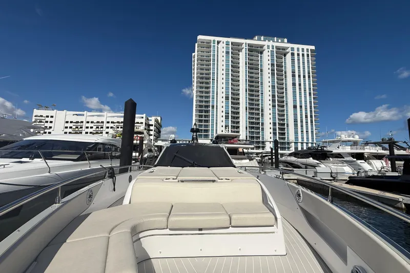 Slide: The Image of 2023 Azimut Verve 47 luxury yacht docked at marina, surrounded by other boats. - 7