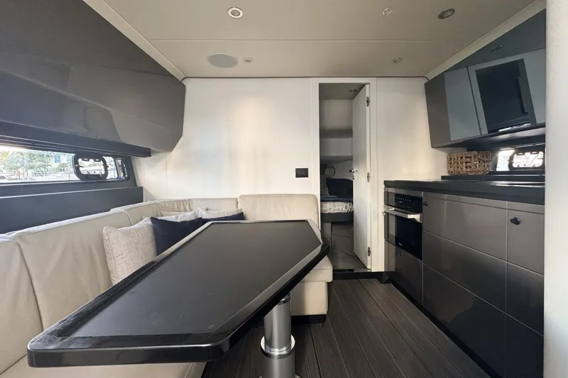 Slide: The Image of 2023 Azimut Verve 47 yacht interior with modern kitchen and seating area. - 78