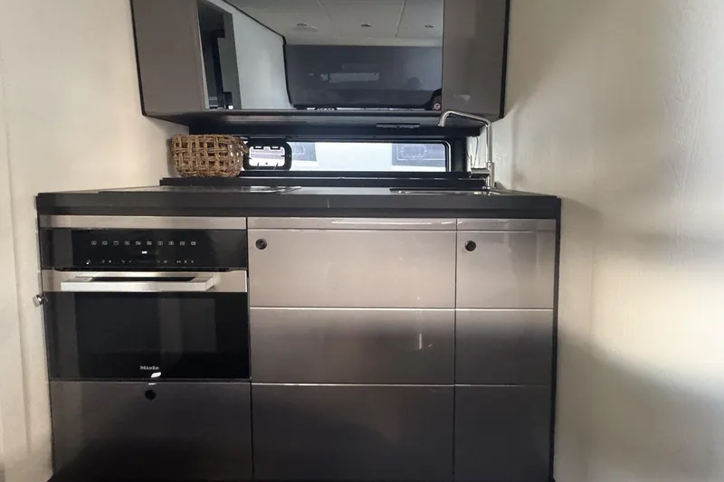 Slide: The Image of Modern kitchen interior on 2023 Azimut Verve 47 yacht, featuring sleek cabinetry and appliances. - 82