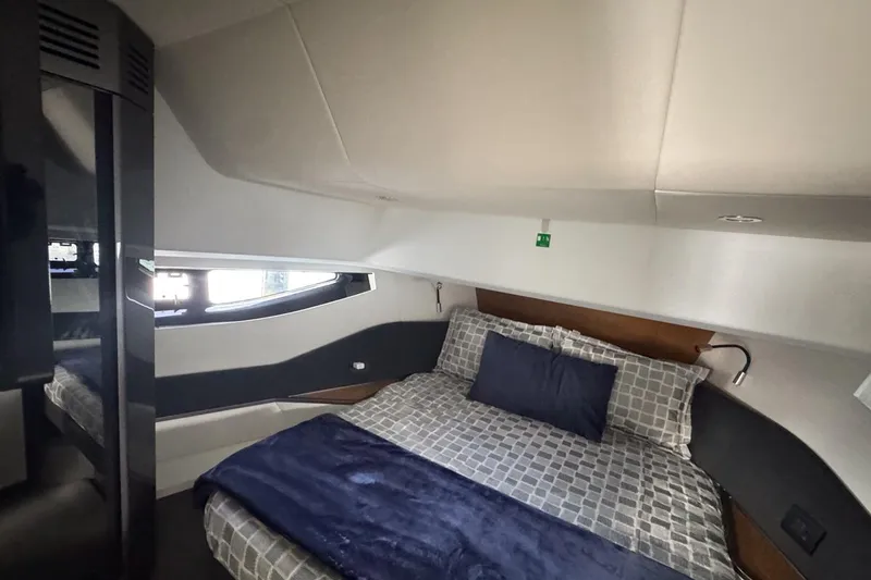 Slide: The Image of Luxurious bedroom interior of 2023 Azimut Verve 47 yacht with modern design and cozy bedding. - 92