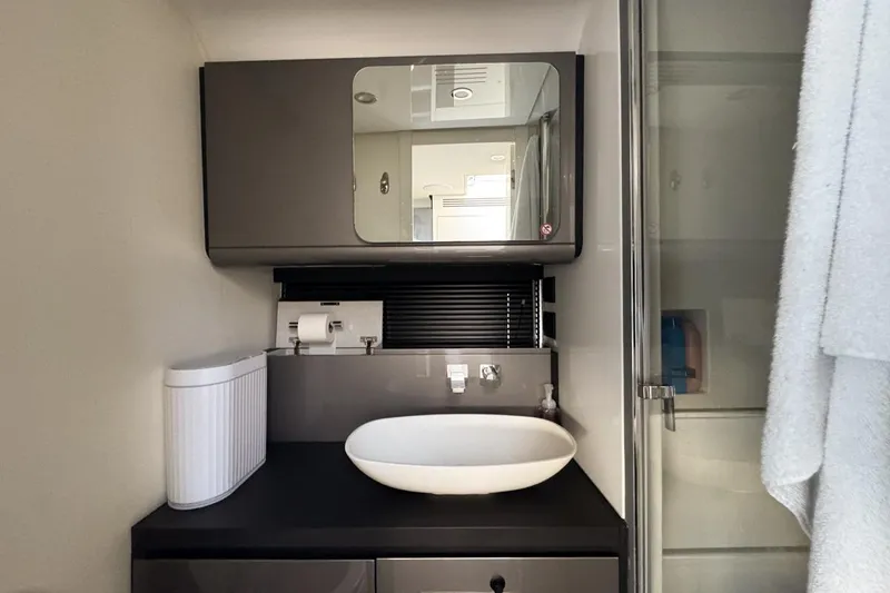 Slide: The Image of Modern bathroom interior of 2023 Azimut Verve 47 yacht, featuring sleek sink and mirror. - 99