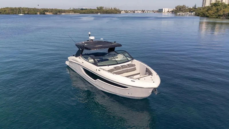 Slide: The Image of 2021 Cruisers Yachts 38 GLS OB 450R on calm blue water. - 11