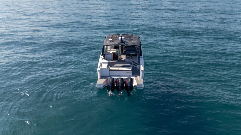 Slide: The Image of 2021 Cruisers Yachts 38 GLS OB 450R on open water, rear view. - 19