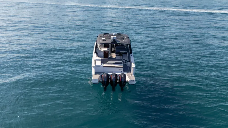 Slide: The Image of 2021 Cruisers Yachts 38 GLS OB 450R on open water, rear view. - 22