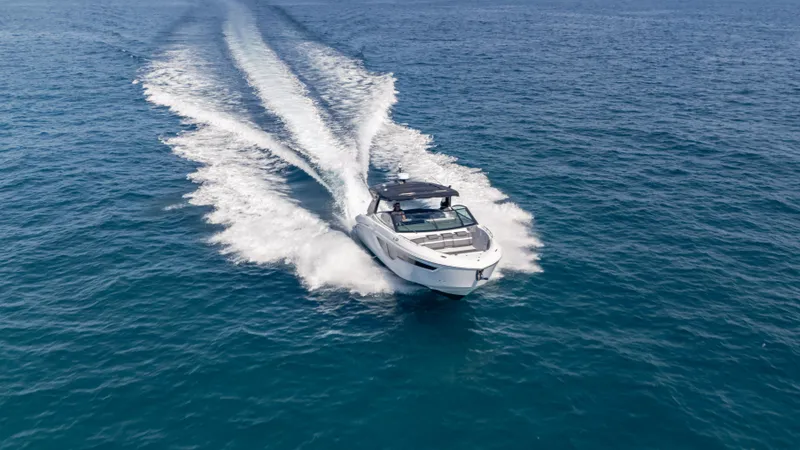 Slide: The Image of 2021 Cruisers Yachts 38 GLS OB 450R speeding on open water, leaving a wake trail. - 27