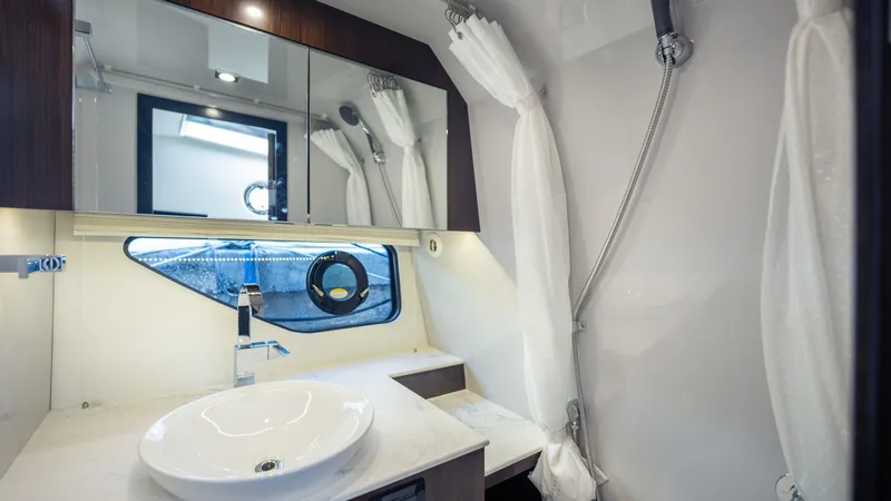 Slide: The Image of Modern bathroom in 2021 Cruisers Yachts 38 GLS OB 450R with sleek fixtures and mirror. - 33