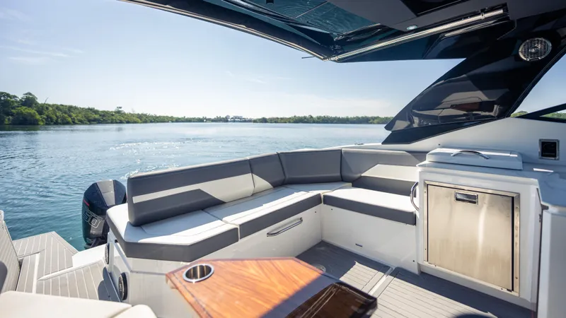 Slide: The Image of Luxurious 2021 Cruisers Yachts 38 GLS OB 450R with sleek seating and scenic water view. - 35