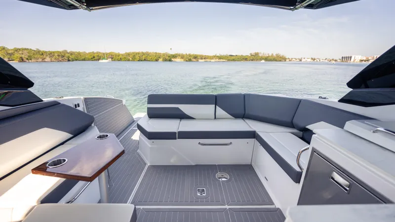 Slide: The Image of 2021 Cruisers Yachts 38 GLS OB 450R interior with sleek seating and scenic water view. - 38