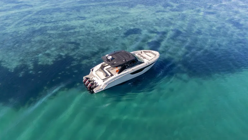Slide: The Image of 2021 Cruisers Yachts 38 GLS OB 450R on clear blue water, aerial view. - 4