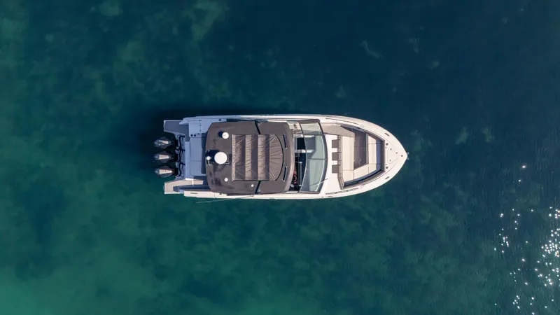 Slide: The Image of Aerial view of 2021 Cruisers Yachts 38 GLS OB 450R on clear water. - 12