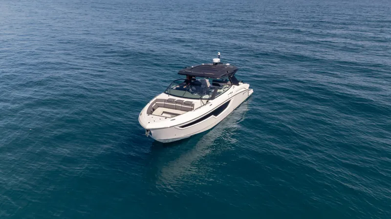 Slide: The Image of 2021 Cruisers Yachts 38 GLS OB 450R on open water, showcasing sleek design and luxury. - 17