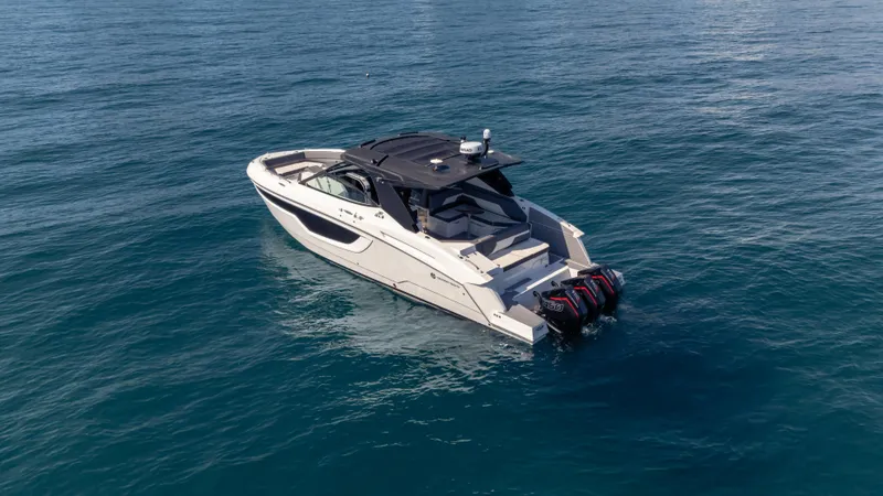 Slide: The Image of 2021 Cruisers Yachts 38 GLS OB 450R on open water, showcasing sleek design and powerful engines. - 18