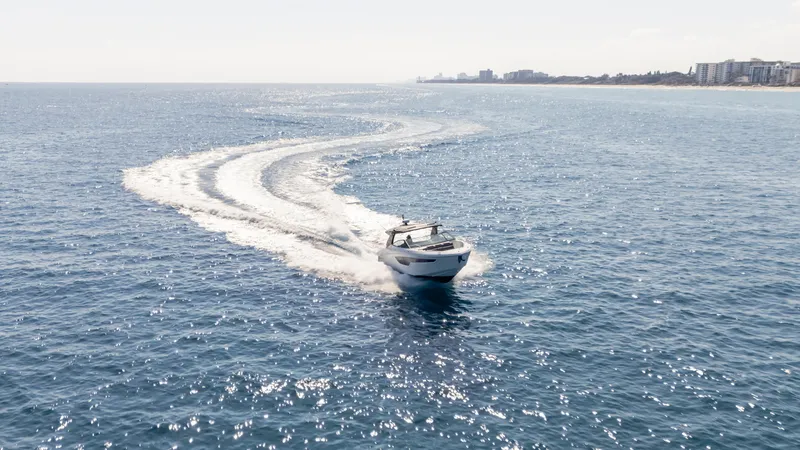 Slide: The Image of 2021 Cruisers Yachts 38 GLS OB 450R cruising on open sea, leaving a wake trail. - 28