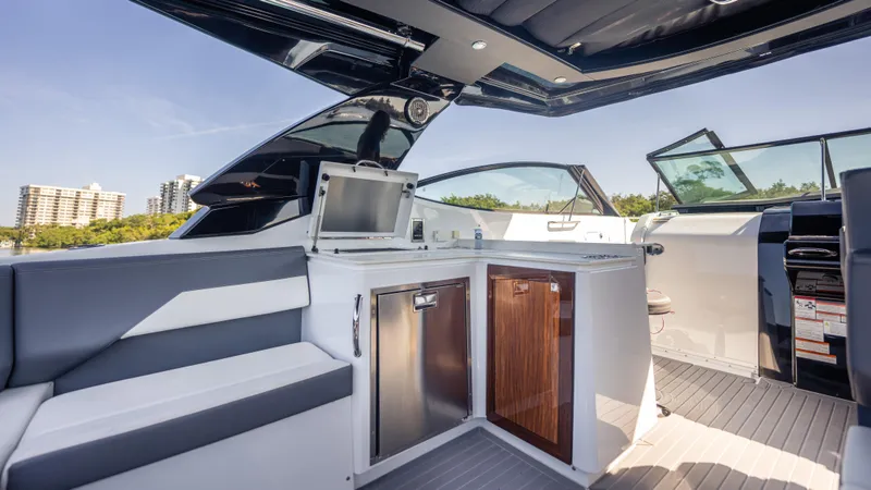 Slide: The Image of 2021 Cruisers Yachts 38 GLS OB 450R interior with modern seating and kitchenette. - 39