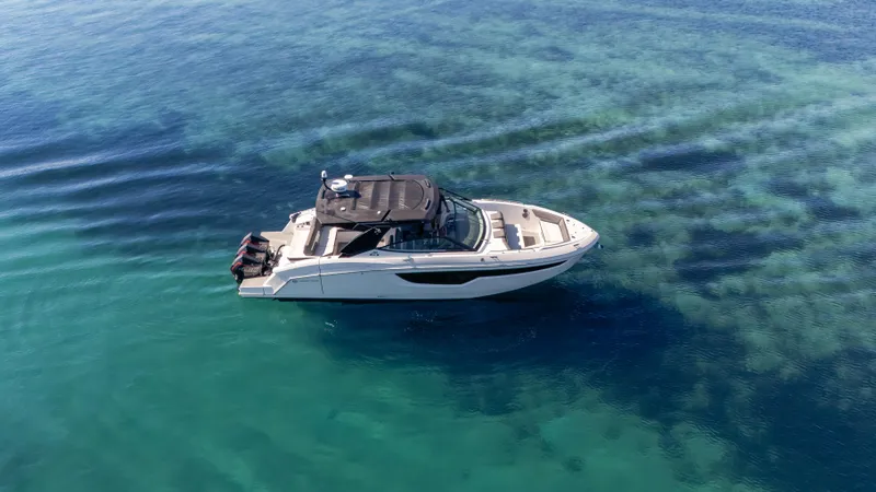 Slide: The Image of 2021 Cruisers Yachts 38 GLS OB 450R on clear blue water, aerial view. - 5