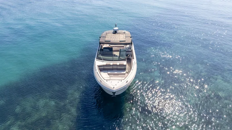 Slide: The Image of 2021 Cruisers Yachts 38 GLS OB 450R on clear blue water, aerial view. - 6