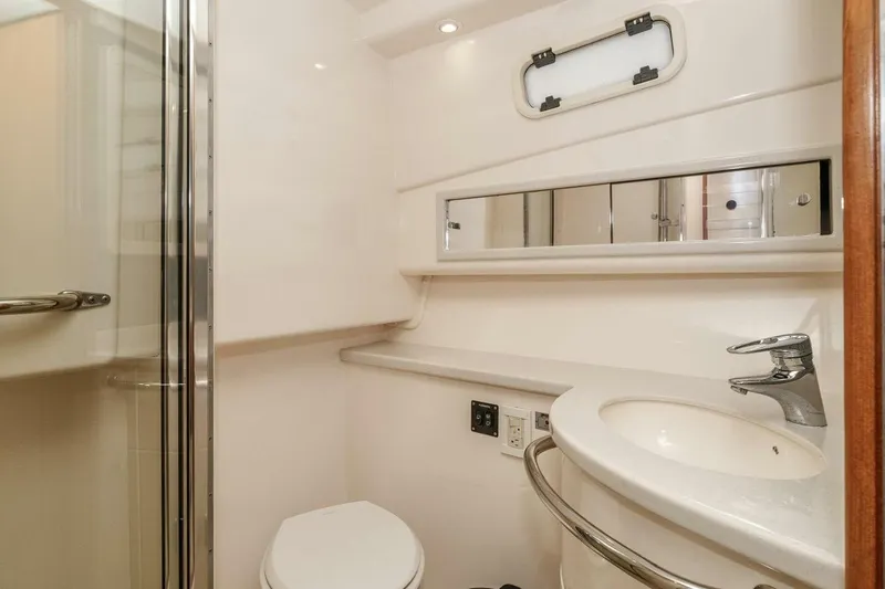 Slide: The Image of 2008 Cabo Yachts 38 EXPRESS bathroom with shower, sink, and mirror. - 12