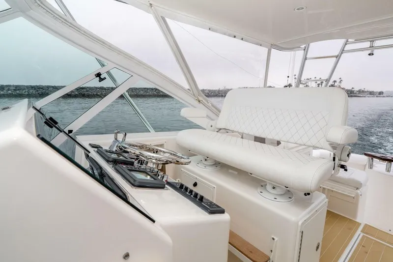 Slide: The Image of Helm of 2008 Cabo Yachts 38 EXPRESS with white seating and steering wheel. - 20