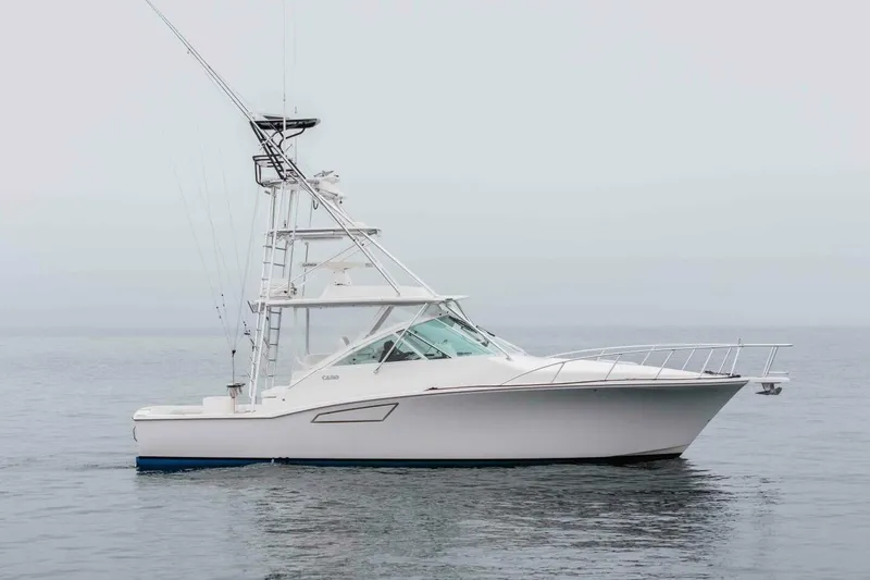 Slide: The Image of 2008 Cabo Yachts 38 EXPRESS fishing boat on calm water, side view. - 22