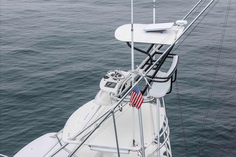 Slide: The Image of 2008 Cabo Yachts 38 EXPRESS tower with American flag over calm ocean. - 29