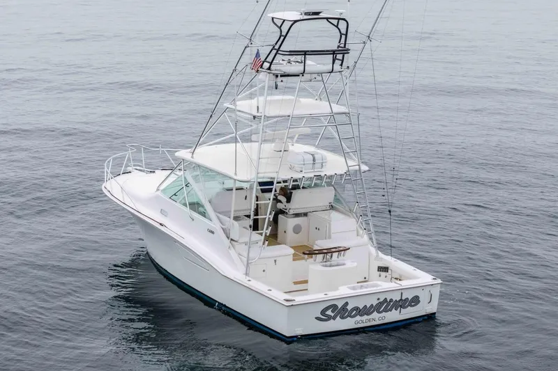 Slide: The Image of 2008 Cabo Yachts 38 EXPRESS fishing boat on calm ocean waters. - 33