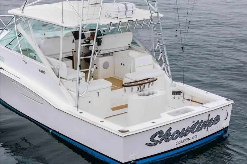 Slide: The Image of 2008 Cabo Yachts 38 EXPRESS boat on water, featuring spacious deck and fishing equipment. - 34