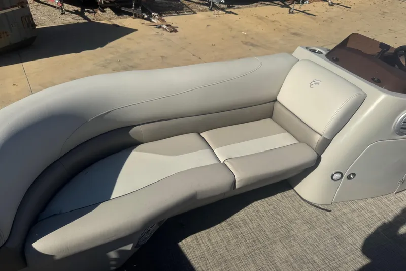 Slide: The Image of 2023 Cypress Cay Seabreeze 232 boat interior with beige seating and console. - 4