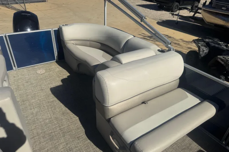 Slide: The Image of 2023 Cypress Cay Seabreeze 232 pontoon boat interior with beige seating and carpeted floor. - 6