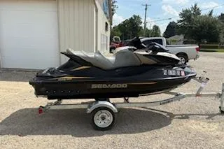 Slide: The Image of 2017 Sea-Doo GTX 155 jet ski on trailer, parked outdoors. - 1
