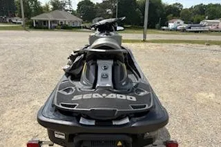 Slide: The Image of 2017 Sea-Doo GTX 155 jet ski parked on gravel lot, rear view. - 2