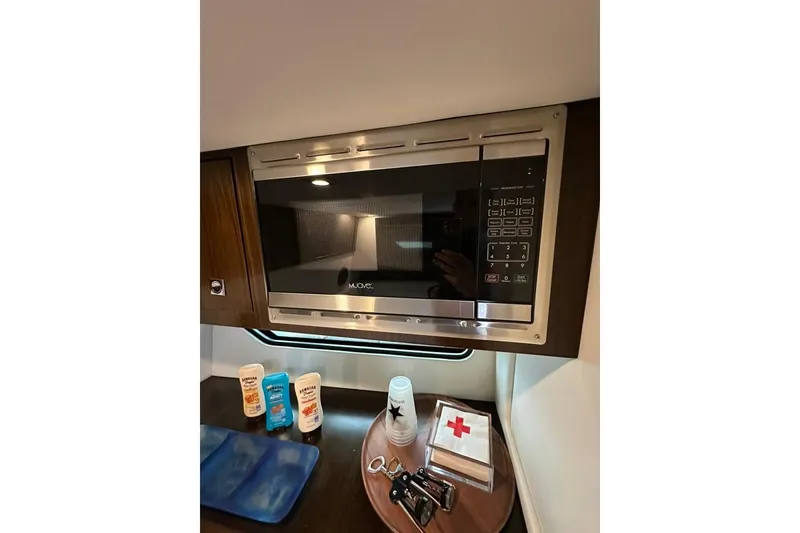 Slide: The Image of Microwave and essentials inside 2021 Cruisers Yachts 338 South Beach Edition Bow Rider. - 15