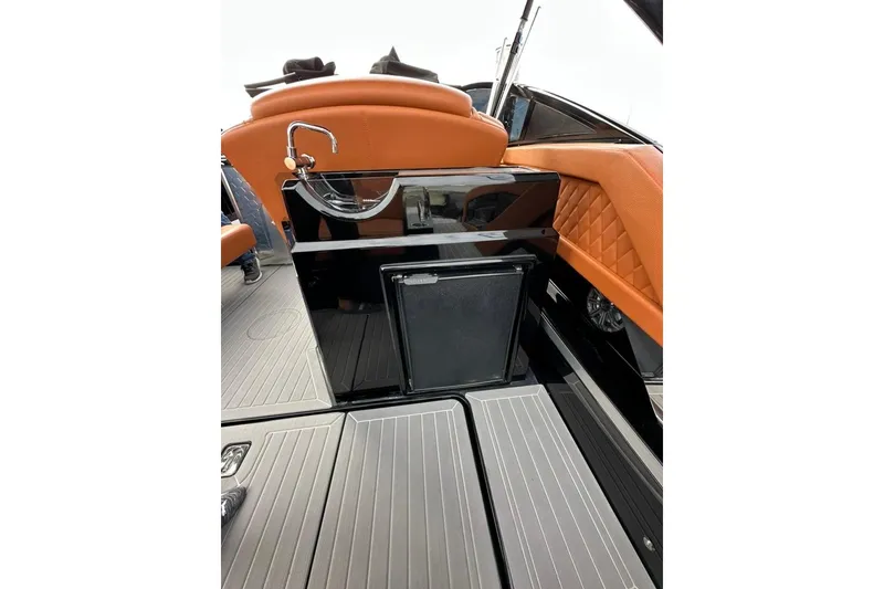 Slide: The Image of 2021 Cruisers Yachts 338 South Beach Edition Bow Rider interior with sleek design and orange accents. - 28